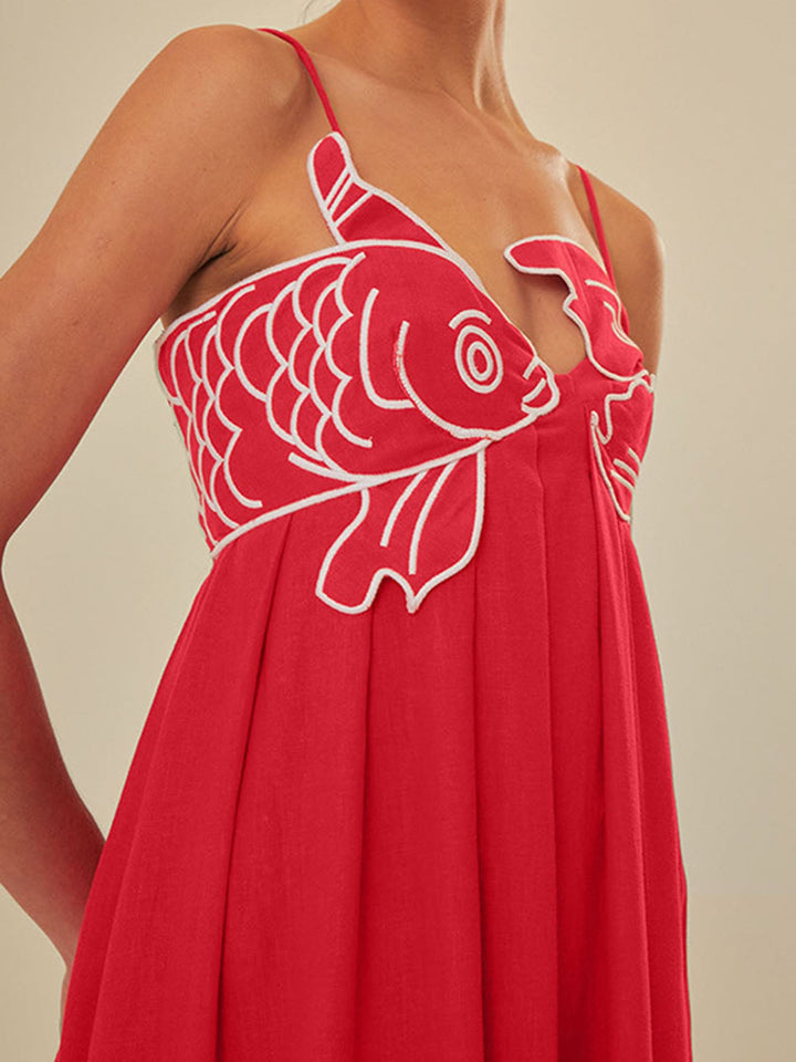 Woman in a black embroidered spaghetti strap maxi dress, front view, styled for a casual summer occasion