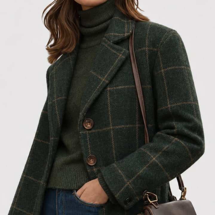 Front view of the Mariza green overcoat showing tailored cut, pockets, and secure closure detail