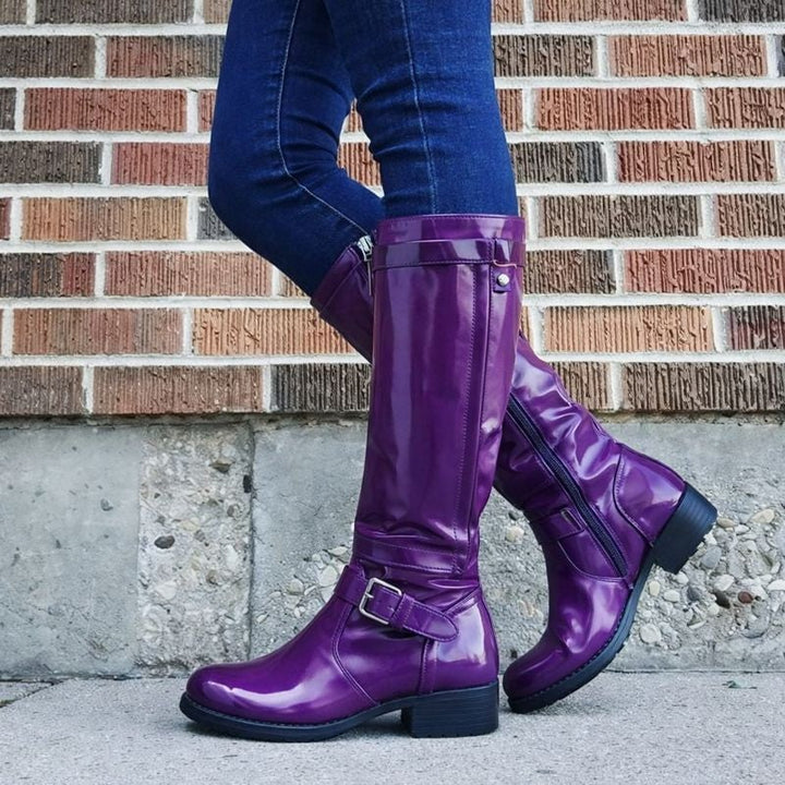 Flatlay of classic round toe knee-high boots in multiple color options including black, brown, and purple