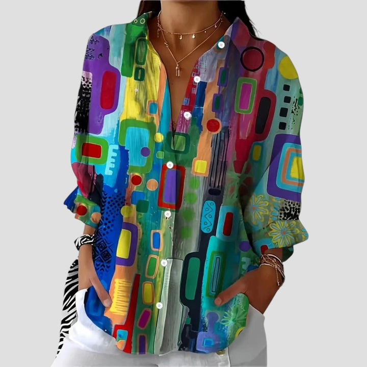 Woman wearing a lightweight geometric-print blouse with a flattering fluid silhouette, front view