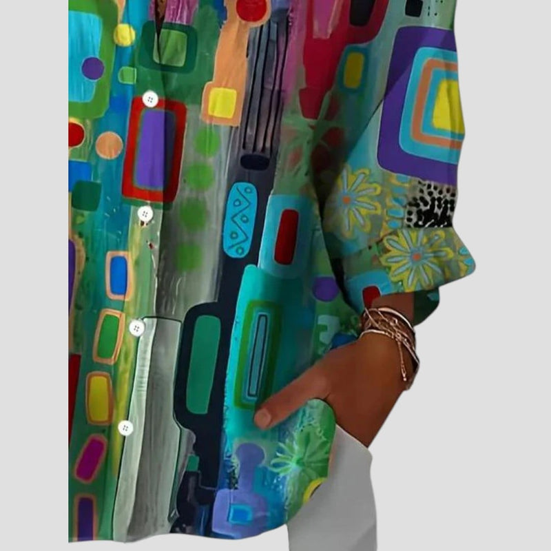 Woman styling the geometric blouse with trousers for a polished, put-together look