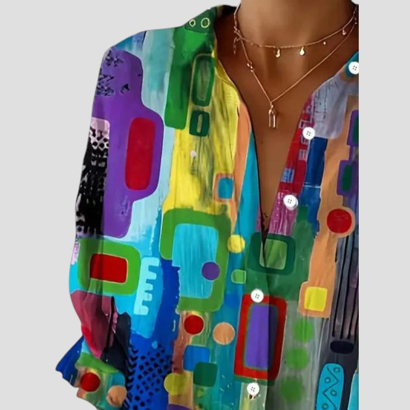 Side view of the geometric-print blouse showing its relaxed, draped fit and breathable fabric