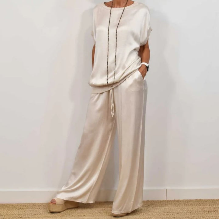 Model wearing the Marla two-piece blouse and pants set in white, front view showing relaxed silhouette and flowing fabric