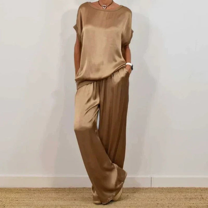 Side view of the Marla flowing pants and blouse set in gray, showing full-length drape