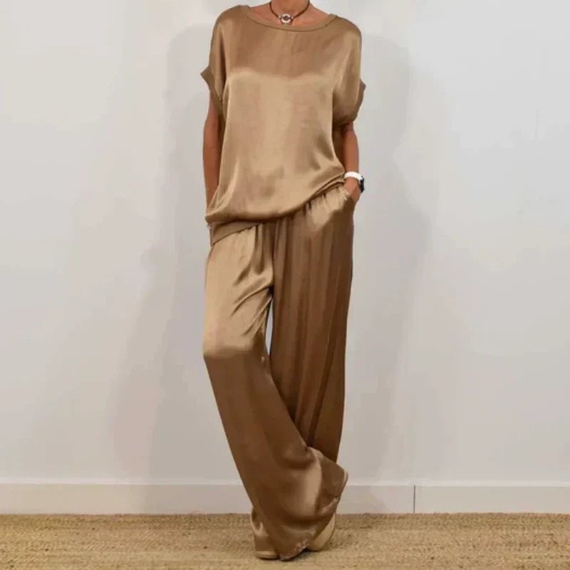 Side view of the Marla flowing pants and blouse set in gray, showing full-length drape