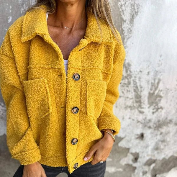 Woman wearing a yellow short lapel collar jacket with button closure, styled for a casual autumn look