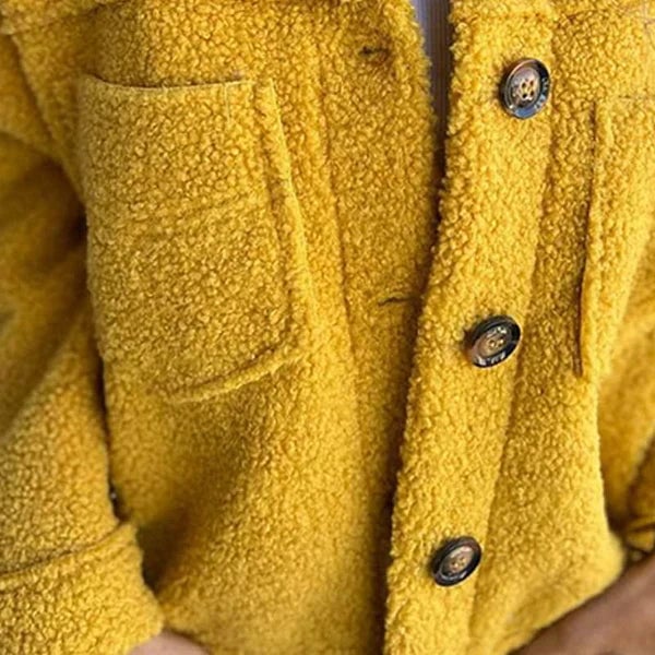 Close-up detail of the refined lapel collar and sleek buttons on the Marleau jacket in pink