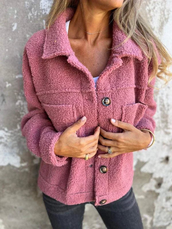 Flat lay of the Marleau jacket in pink displaying the soft premium fabric texture and button detail