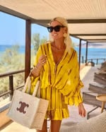 Woman styling the Marlowe mini dress with heeled sandals for an evening look