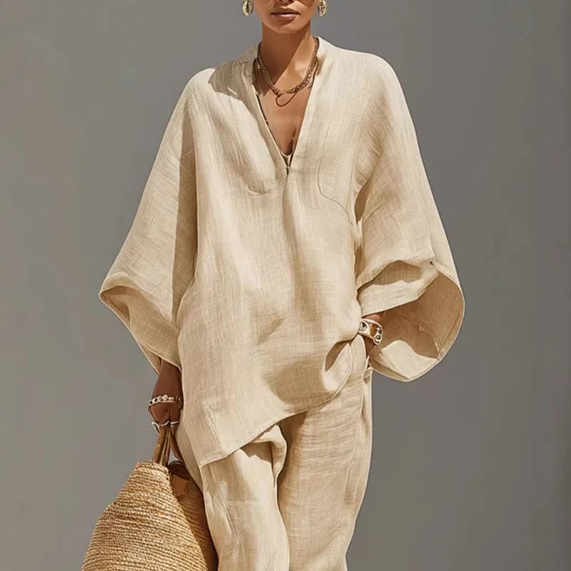 Woman wearing the Marlowe batwing sleeve two piece set in apricot with tapered pants and wide flowing sleeves