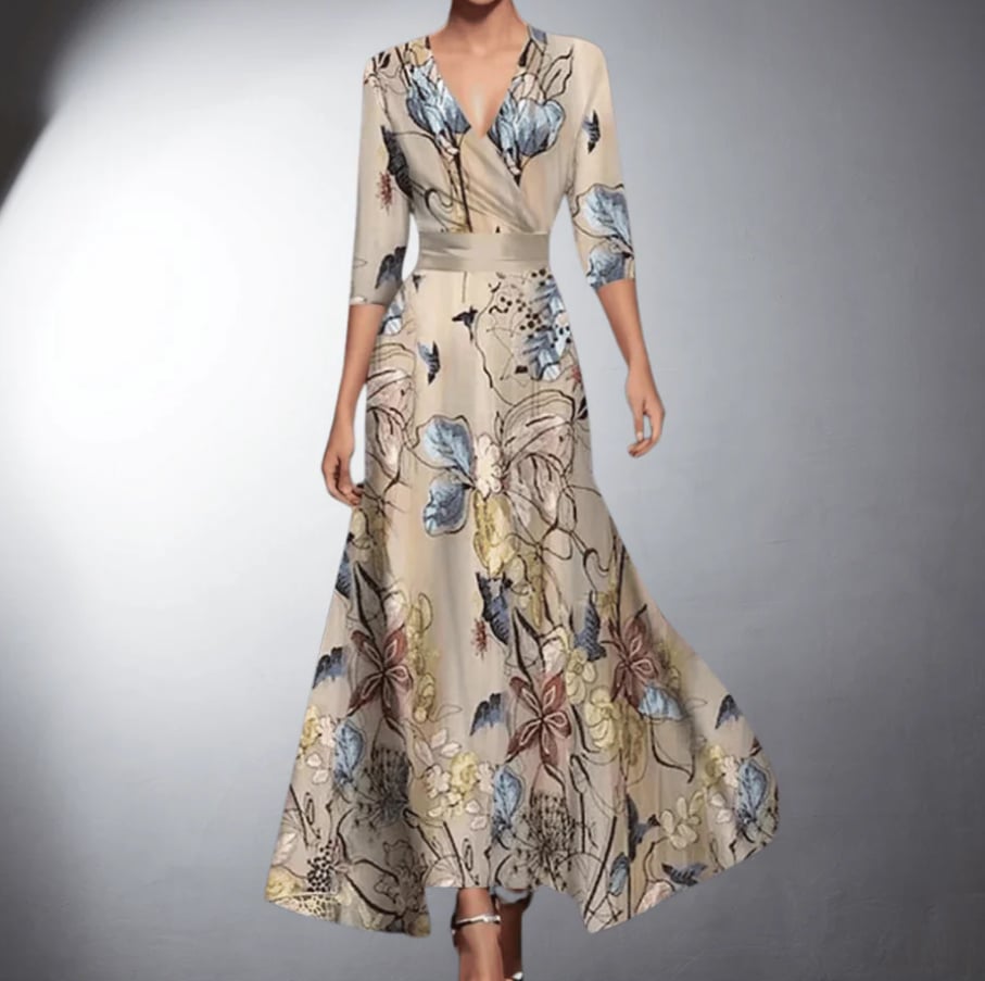 Woman wearing a flowing floral maxi dress with a romantic print in soft, warm colors