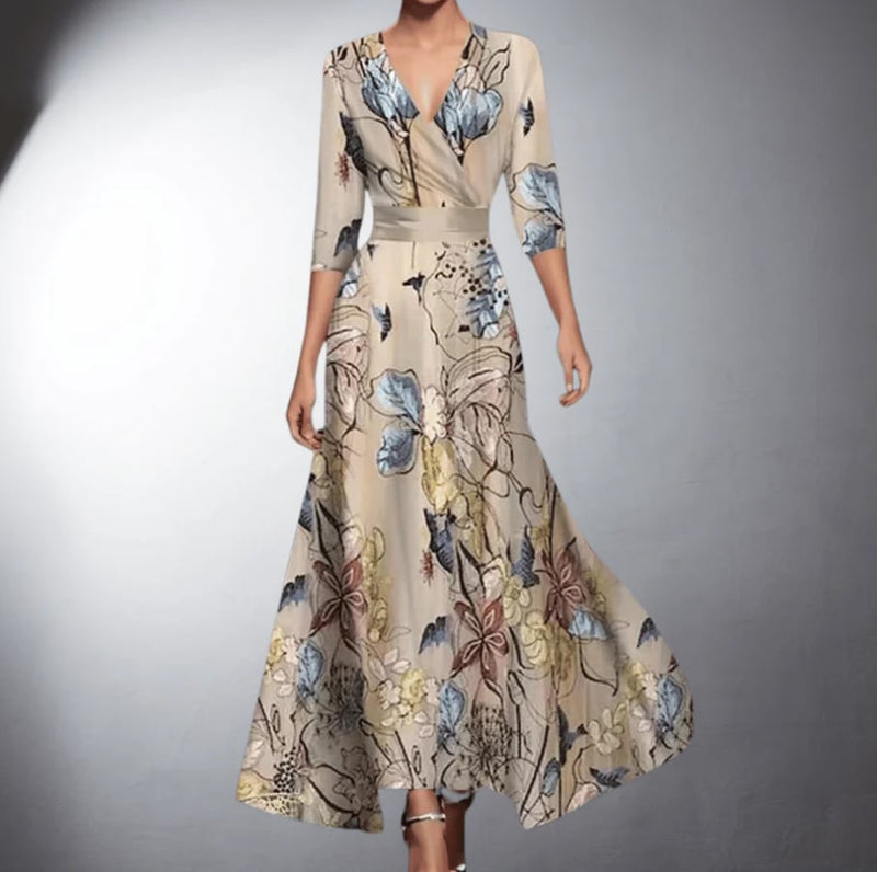 Woman wearing a flowing floral maxi dress with a romantic print in soft, warm colors