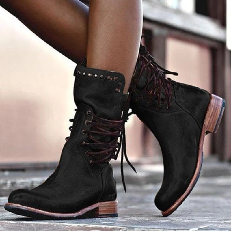 Women's classic comfort boot in black displayed on a clean white background, highlighting the durable construction