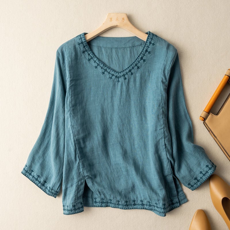 Relaxed fit embroidered blouse styled casually, shown in a soft pink colorway