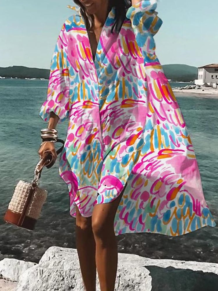 Front view of a vibrant printed midi shirt dress in a flowy oversized silhouette on a female model