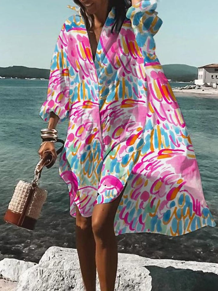 Front view of a vibrant printed midi shirt dress in a flowy oversized silhouette on a female model