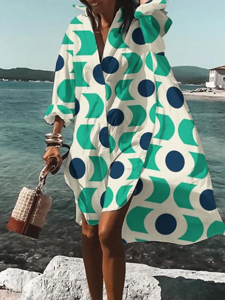 Woman in an orange oversized midi shirt dress posing outdoors in a casual summer outfit