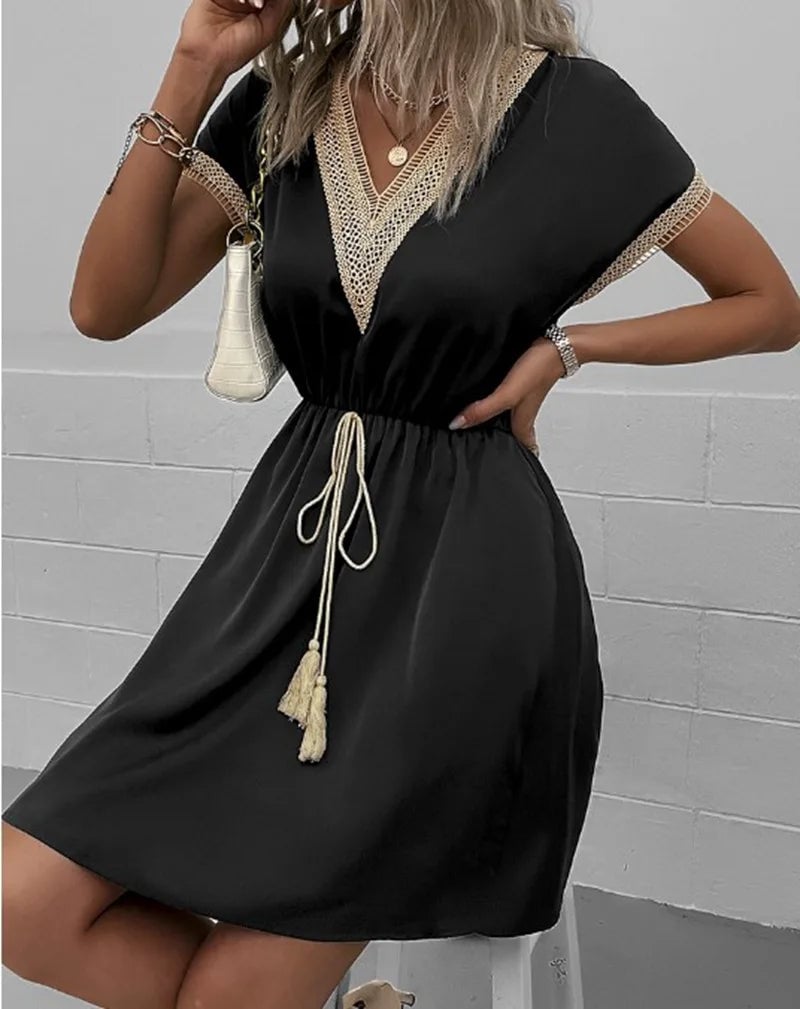 Woman in a light green boho flowy dress posing outdoors, showing the fluid fabric drape