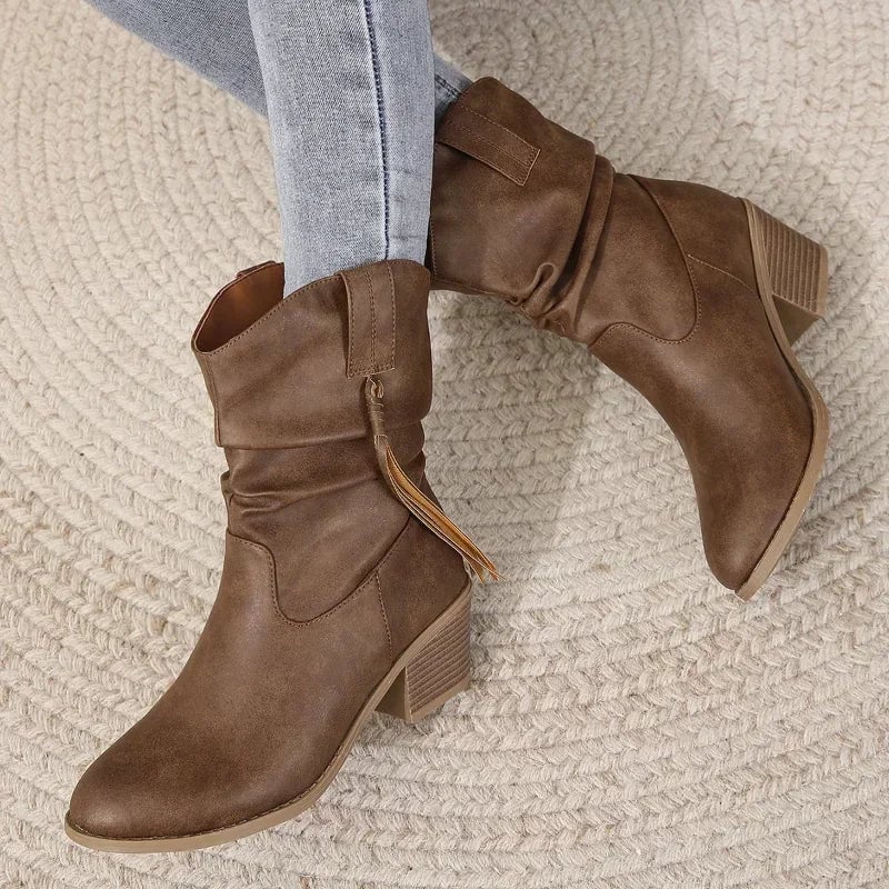 Close-up of dark brown western boot upper highlighting curved silhouette and Western stitching detail