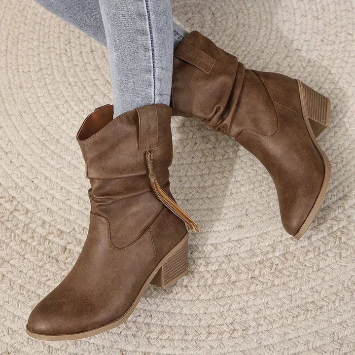 Close-up of dark brown western boot upper highlighting curved silhouette and Western stitching detail