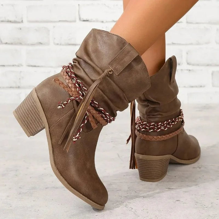 Side view of dark brown western boots showing mid-calf height and supportive sole