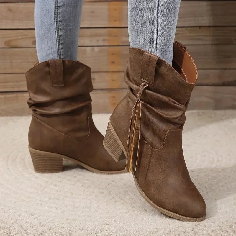 Dark brown western boots styled with denim jeans on a female model