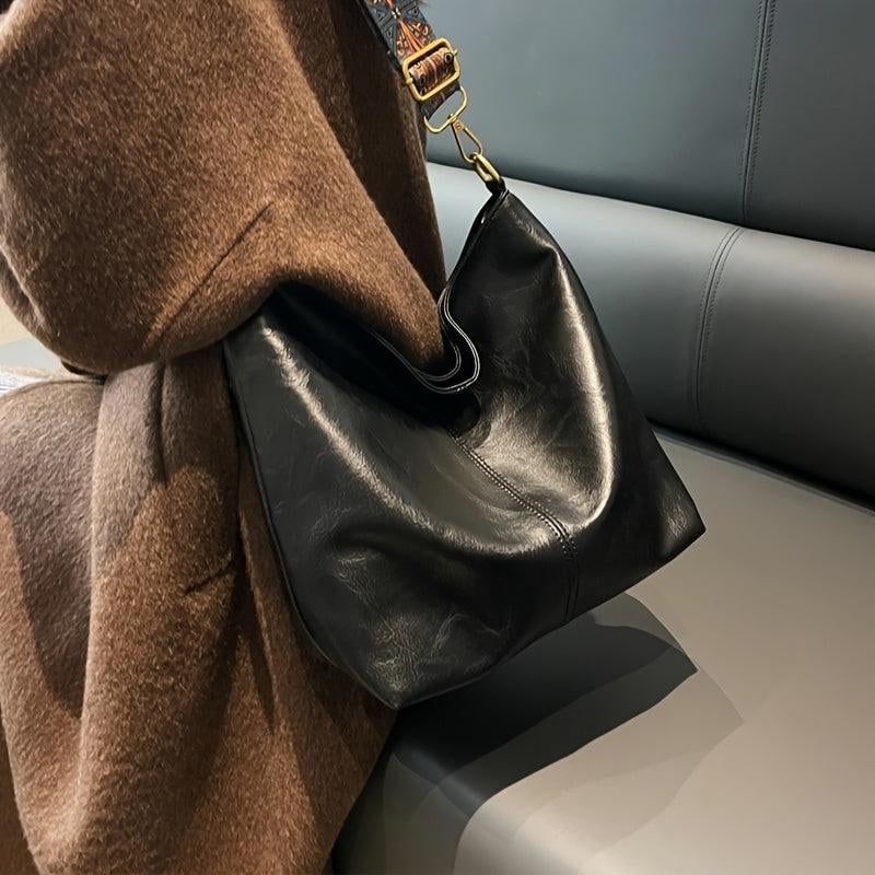 Green fashion shoulder bag against neutral background, front view