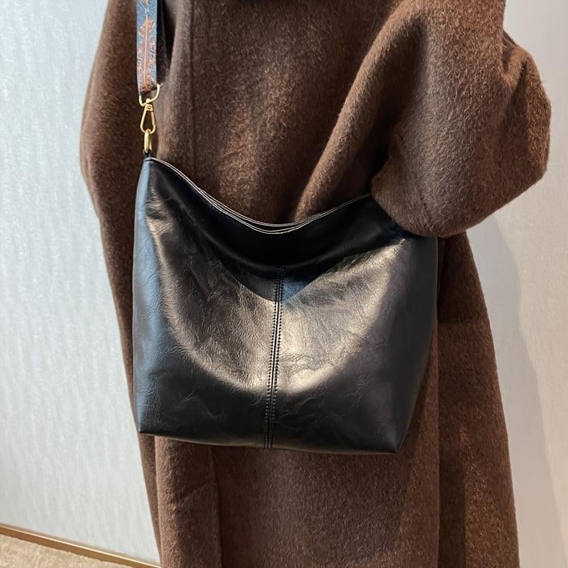 Brown classy fashion bag held by model, lifestyle shot