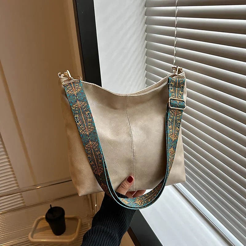 Beige fashion bag showing structured silhouette, side view