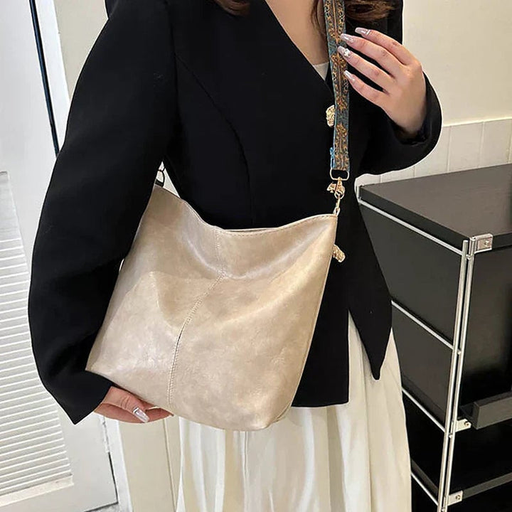 Green fashion bag flat lay with styling accessories