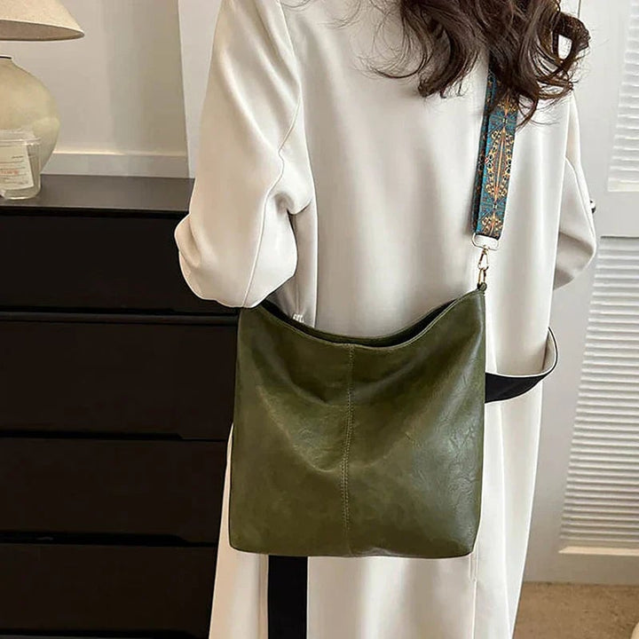 Black classy fashion bag on model shoulder, street style shot