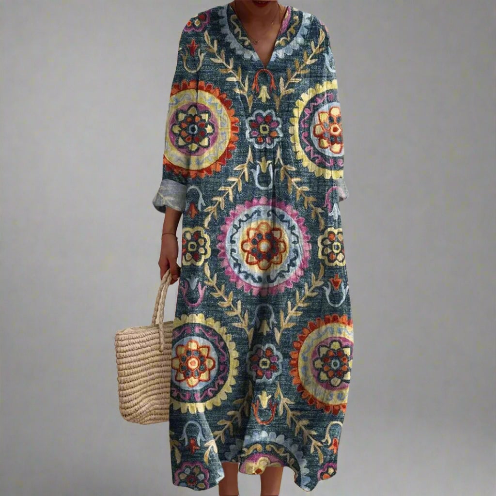 Model wearing a flowing geometric print dress with a relaxed, flattering silhouette in a bold modern pattern