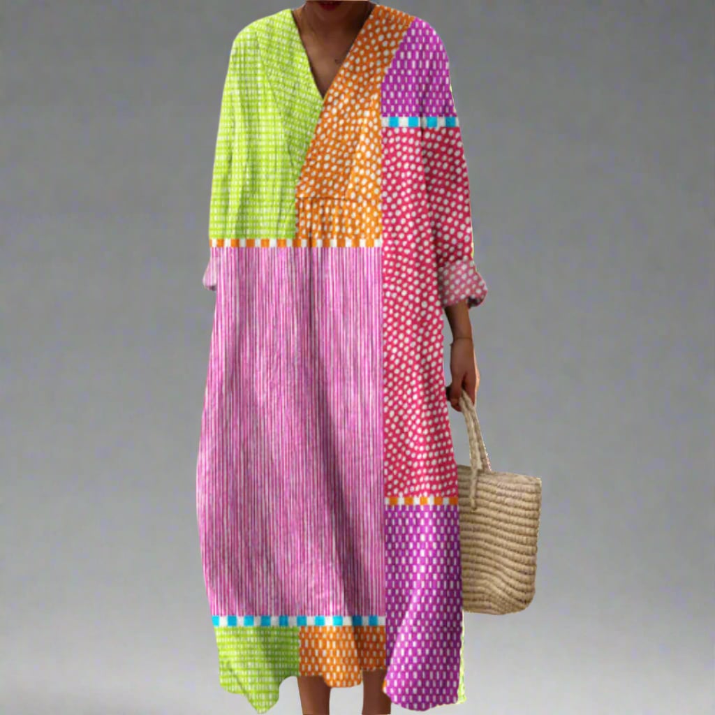 Woman wearing an elegant flowing dress with a bold abstract geometric print in a relaxed flattering silhouette