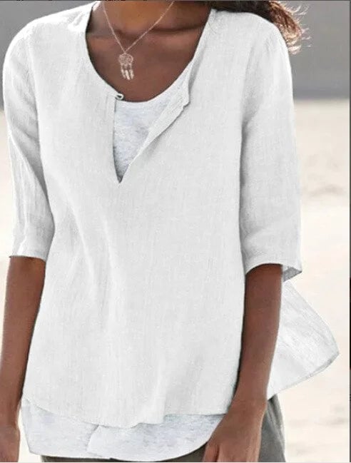 Front view of Maya linen blouse in white showing high-low hem and contrast underlayer detail