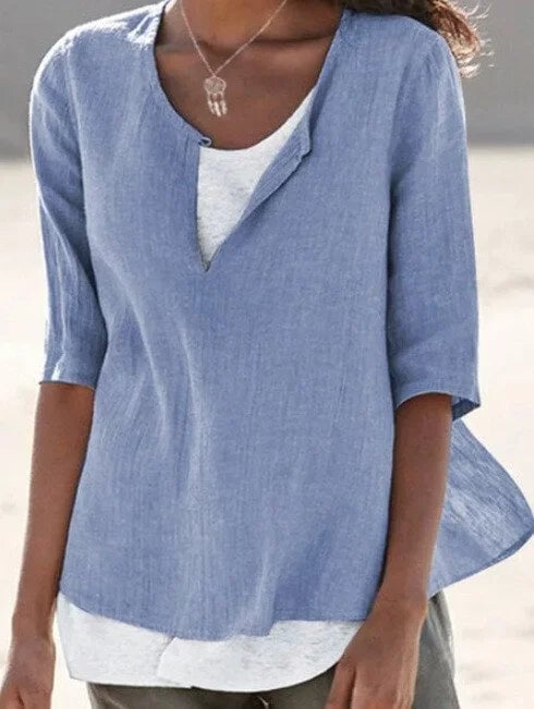 Side view of women's casual split neck blouse in light blue with 3/4 length sleeves
