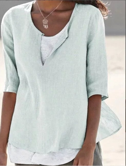 Close-up of the layered hem detail and split neckline on the Maya women's linen blouse in blue