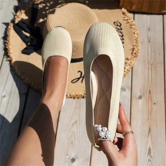Maya knit slip-on flat in blue shown from the back angle to display the heel and overall silhouette