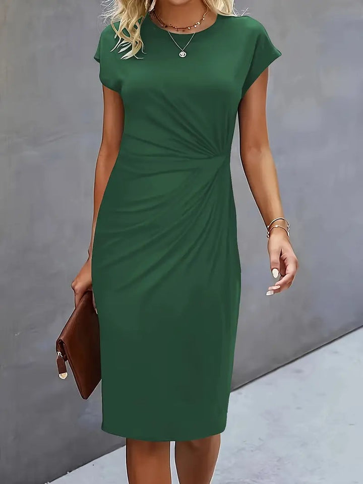 Side view of the Maya ruched midi dress in black showing the bodycon fit