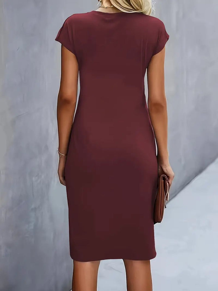 Full-length side view of the Maya midi dress in violet with cap sleeve detail
