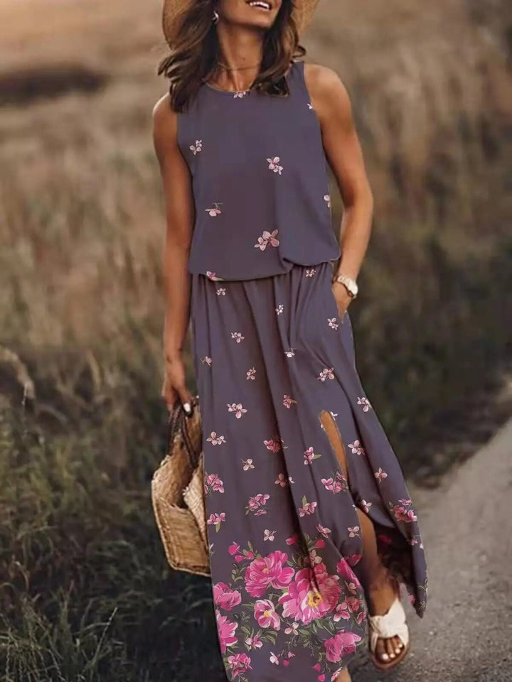 Woman in the Maya sleeveless maxi dress in purple, showing the floor-length flowing skirt from the side