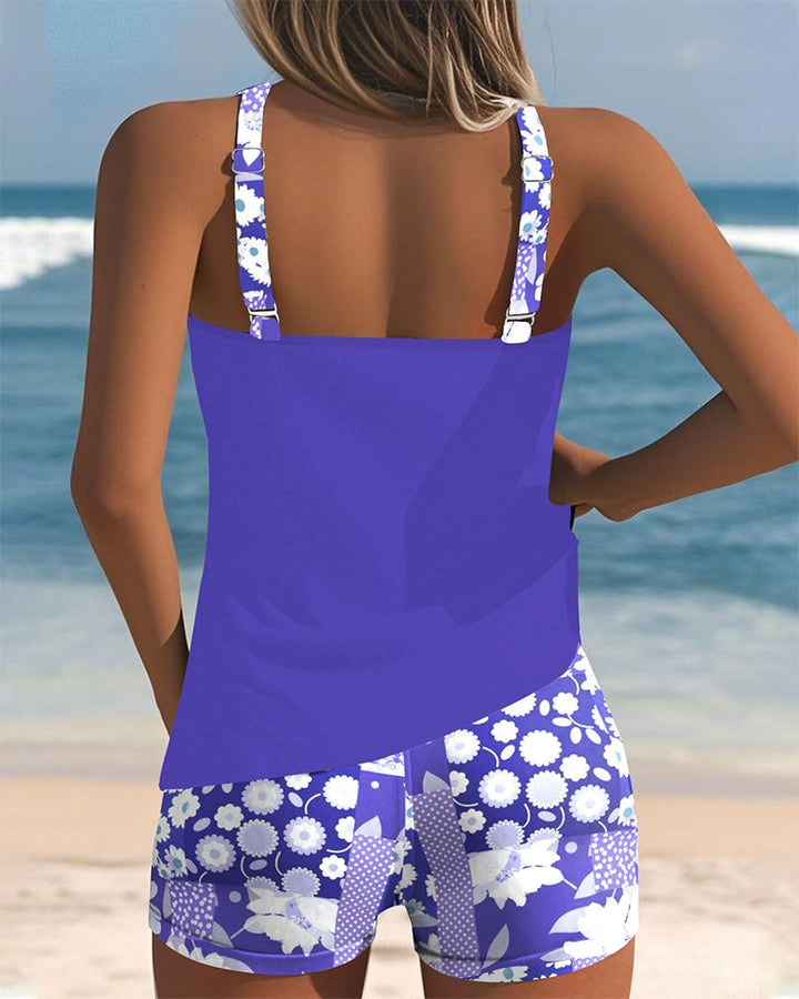 Front view of the Melanie two-piece swimsuit set in light blue floral print on a model