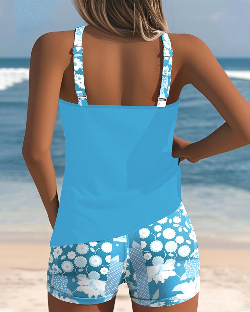 Overhead flat-lay of the full Melanie two-piece swimsuit set in blue floral print
