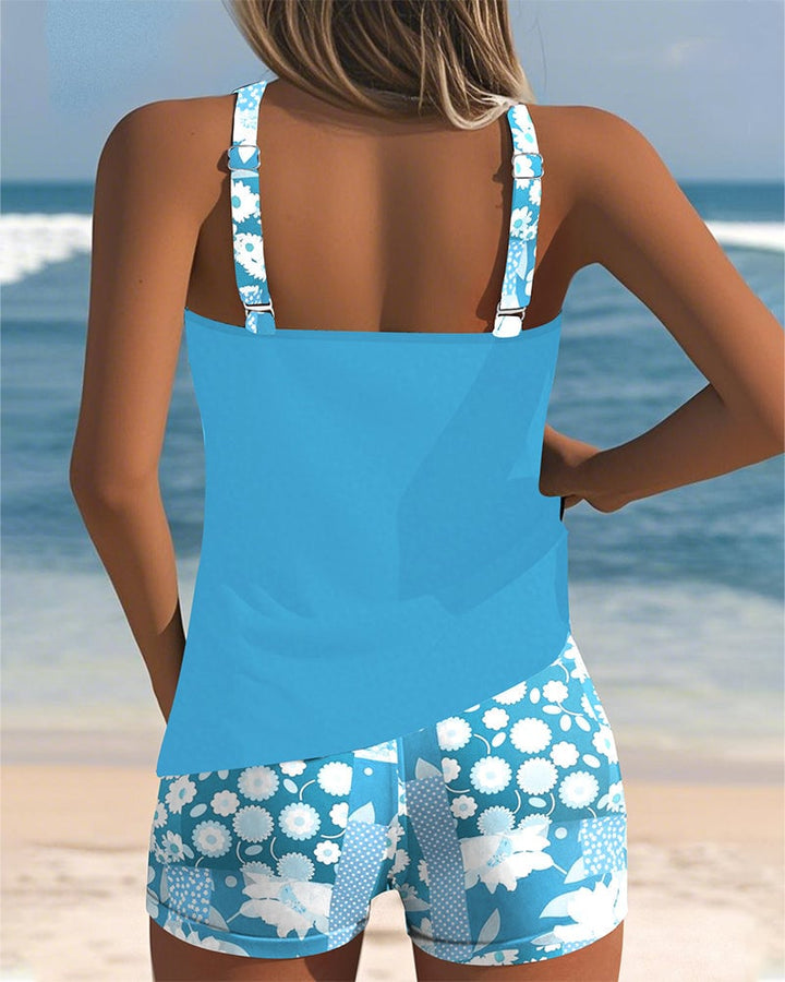 Overhead flat-lay of the full Melanie two-piece swimsuit set in blue floral print