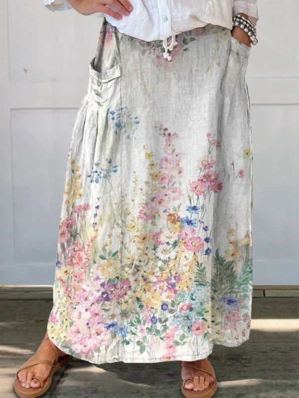 Woman styling a white retro floral skirt with a casual top and sandals