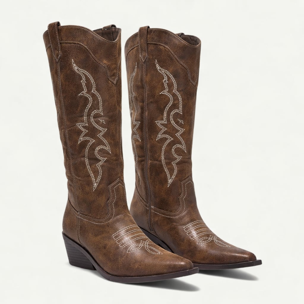 Close-up of the pointed toe detail on brown western calf-high boots