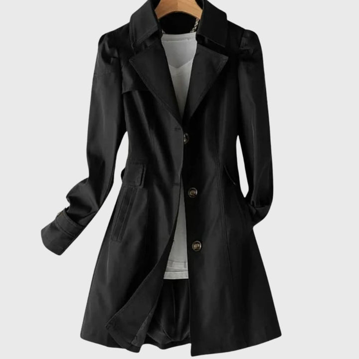 Close-up detail of the everyday rain coat showing adjustable closures, pockets, and clean stitching