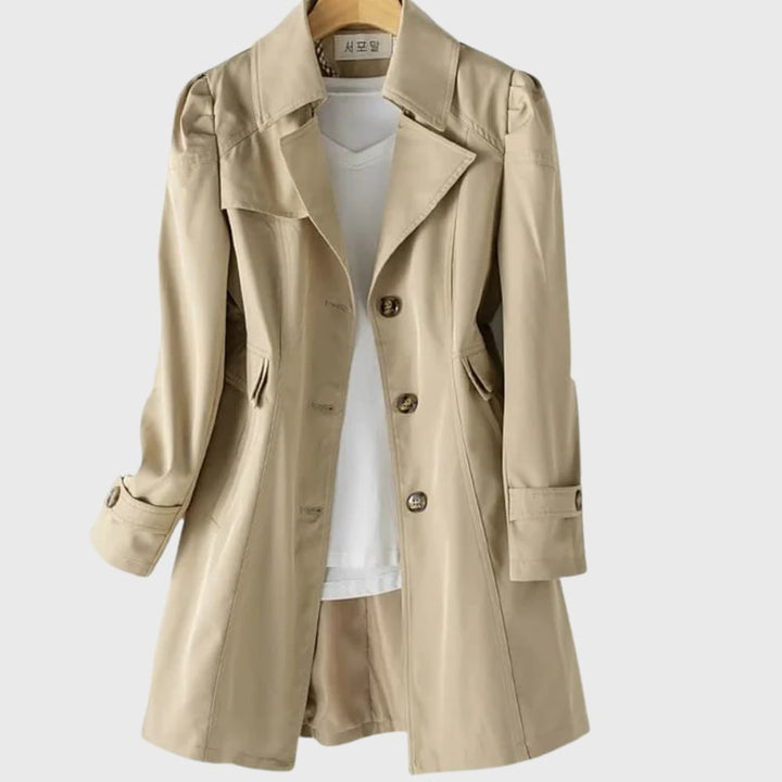 Woman in the everyday rain coat styled over a casual outfit, highlighting the sleek elongating silhouette