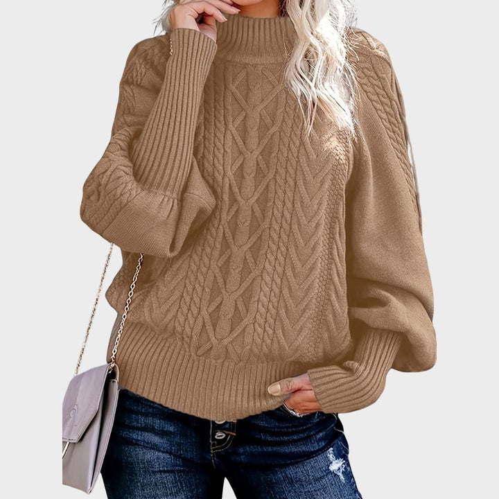 Woman wearing a relaxed-fit long sleeve sweater in khaki, styled with jeans for a casual everyday look