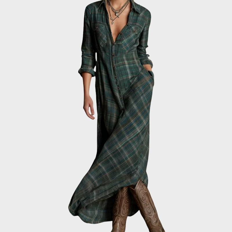 Woman wearing a dark green flowing maxi dress with a lengthening silhouette, front view
