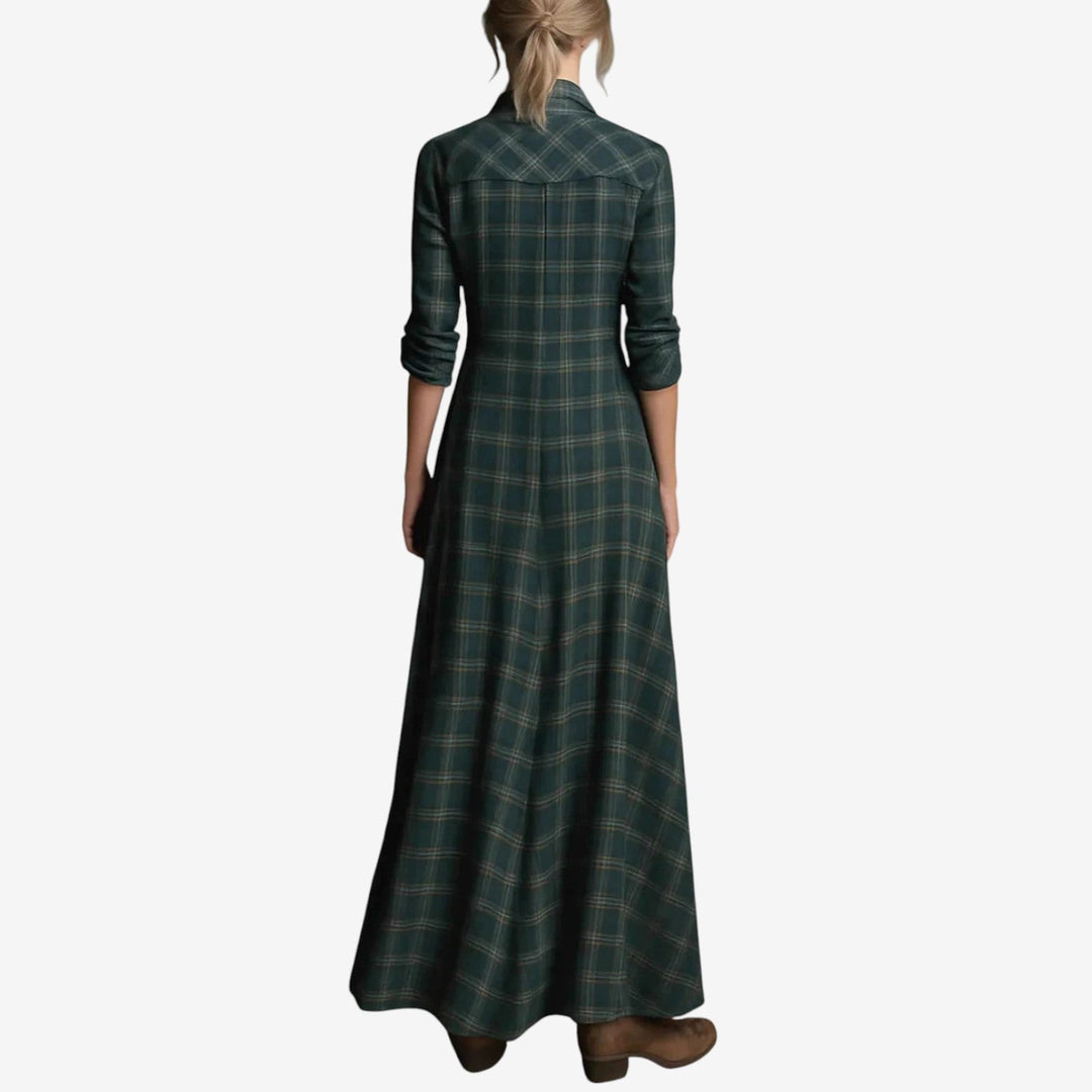 Close-up of dark green maxi dress fabric showing smooth drape and sleeve detail